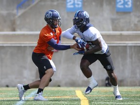 Toronto Argonauts McLeod Bethel-Thompson QB (4) hands off to teammate James Wilder Jr. (32) at practice. Jack Boland/Toronto Sun/Postmedia Network