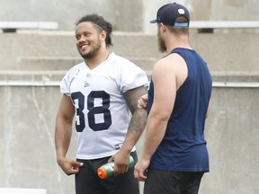Argos fullback Declan Cross (left), chatting with teammate Jeff Finley, believes emotion and execution should go hand-in-hand, but haven’t been in their past two games, most notably in the second halves when the Boatmen have scored only nine points.  Jack Boland/Toronto Sun
