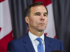 Federal Liberal incumbent candidate Bill Morneau listens during an announcement by federal Liberal leader Justin Trudeau at a campaign event in Toronto on Sept. 20, 2019.