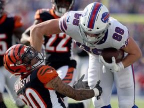 Jessie Bates of the Cincinnati Bengals is run over by Dawson Knox of the Buffalo Bills during a game at New Era Field on September 22, 2019 in Orchard Park, N.Y. (Bryan M. Bennett/Getty Images)