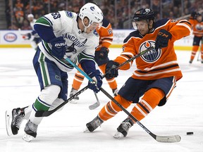 Edmonton Oilers' Matthew Benning (83) battles the Vancouver Canucks' Bo Horvat (53) at Rogers Place, in Edmonton Thursday Dec. 27, 2018. (David Bloom/Postmedia)