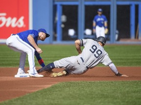 Blue Jays second baseman Brandon Drury (left) tags out Yankees' Aaron Judge (right) at second base during first inning MLB action at Rogers Centre in Toronto on Saturday, Sept. 14, 2019.