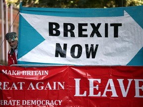 A crown-wearing pro-Brexit demonstrator stands next to banners outside the Supreme Court of the United Kingdom, in London, Britain September 18, 2019.