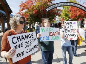 Toni Innes of Madoc demonstrates with her twin sons, Peter and Andrew, 13, at a climate strike in Market Square in Belleville, Ont. on Friday, Sept. 20, 2019. (Luke Hendry/The Intelligencer/Postmedia Network)