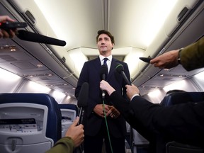 Liberal Leader Justin Trudeau makes a statement in regards to photo coming to light of himself from 2001 wearing "brownface" during a scrum on his campaign plane in Halifax, N.S., on Wednesday, September 18, 2019.