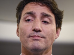 Liberal Leader Justin Trudeau reacts as he makes a statement in regards to photo coming to light of himself from 2001 wearing blackface during a scrum on his campaign plane in Halifax, N.S., on Wednesday, September 18, 2019. THE CANADIAN PRESS/Sean Kilpatrick