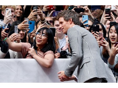 Eddie Redmayne poses for a selfie photo as he arrives at the Canadian premiere of "The Aeronauts" at the Toronto International Film Festival in Toronto, Sept. 8, 2019.