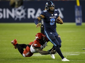 Calgary Stampeders’ Anthony Johnson narrowly misses a tackle on Argonauts quarterback James Franklin during last Friday’s game in Toronto. Franklin is set 
to return as the team’s starting quarterback on Saturday. (THE CANADIAN PRESS)