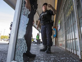 A Toronto Police officer is pictured Wednesday at Yorkwoods Plaza on Jane St., near Finch Ave. (Ernest Doroszuk, Toronto Sun)
