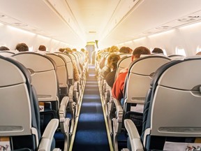 When your plane lands, avoid the urge to run to the front of the aisle to exit first. Following etiquette can help make the deplaning experience better for everyone. (Getty Images)