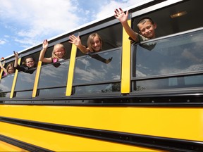 Children waving from school bus