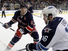 Former New York Rangers defenceman Dan Girardi prepares to hit ex-Winnipeg Jet Andrew Ladd in this 2014 file photo. Girardi retired after 13 seasons in the league. GETTY IMAGES FILE