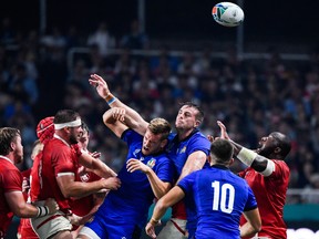 Canada (in red) and Italy (in blue) battle for possession during their Pool B match at the Rugby World Cup in Fukuoka, Japan. (GETTY IMAGES)