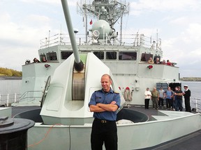 Lt.-Commander Jean Couillard, executive officer of the HMCS Ville de Quebec poses on the ship's deck as visitors receive guided tours of the ship at Cornwall Harbour in this file photo.