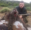 A Brit hunter poses with the baboon he killed in South Africa. 