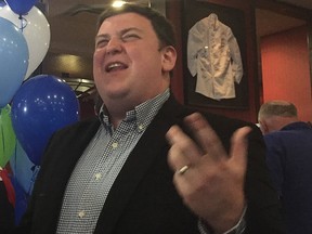 In this June 7, 2018, file photo, then-Ontario PC candidate Andrew Lawton talks with supporters at a party after losing the London West riding race to NDP's Peggy Sattler in the Ontario general election.