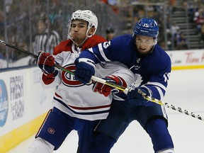 Montreal Canadiens forward Nick Suzuki and Toronto Maple Leafs forward Alexander Kerfoot battle for position during the first period at Scotiabank Arena on Wednesday, Sept. 25, 2019.