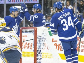 Maple Leafs' Andreas Johnsson (centre left) celebrates with left wing Kenny Agostino (20) and centre Auston Matthews (34) after scoring his team's opening goal against Buffalo Sabres during first period NHL pre-season hockey action in Toronto on Friday, September 20, 2019. (CHRIS YOUNG/THE CANADIAN PRESS)