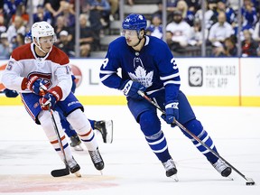Toronto Maple Leafs centre Auston Matthews (34) is defended by Montreal Canadiens centre Jesperi Kotkaniemi (15) in Toronto on Wednesday, September 25, 2019. (THE CANADIAN PRESS/Christopher Katsarov)