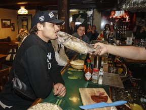Maple Leafs centre Auston Matthews gets into the spirit and kisses a cod at a George St. bar called Christian’s in St. John's, NL. (Toronto Maple Leafs/Twitter)