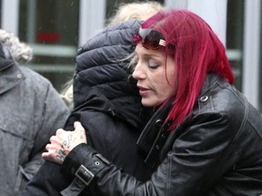 Shanan Dionne, whose daughter Rori Hache was murdered, hugs a friends outside court.