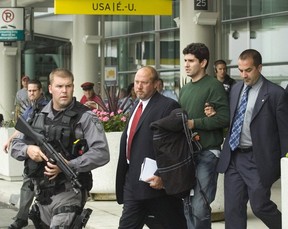 Jorge Alberto Restrepo is escorted out of Pearson by Peel detectives. He pleaded guilty to conspiracy to commit murder.