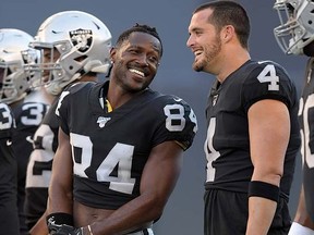 Oakland Raiders wide receiver Antonio Brown, left, and quarterback Derek Carr share laugh before a game against the Green Bay Packers at Investors Group Field. (Kirby Lee-USA TODAY Sports)