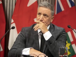 Brad Blair takes a seat as journalists gather at the Ontario Legislature, in Toronto on Friday, Sept. 13, 2019. The Former OPP deputy commissioner was dismissed from the police service and he has issued a $15m lawsuit against Ontario Premier Doug Ford's Government.