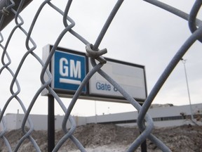 The sign at the GM plant in Oshawa as seen through a fence.
