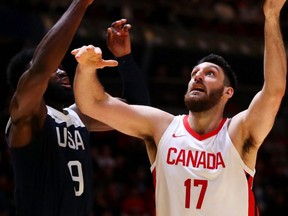 Owen Klassen of Canada (right) lays up a shot during the International Friendly Basketball match against the U.S. at Qudos Bank Arena in Sydney, Australia, on Aug. 26, 2019.