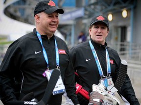 Team Canada coaches Claude Julien, left, and Mike Babcock make their  way to the hockey practice facility at the 2014 Olympic Winter Games in Sochi, Russia, on  February 18, 2014. Al Charest/Postmedia