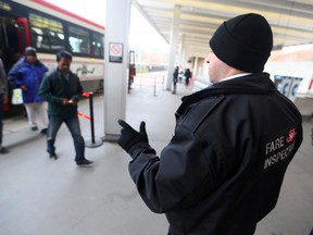 A TTC fare inspector checks tickets at Bathurst station.