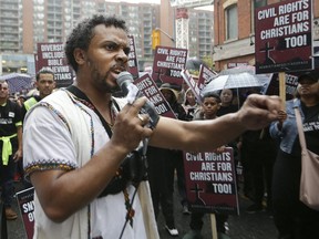 The LGBTQ2 held a "Unite For Love Rally on Church Street as a Christian group, led by David Lynn, held their own rally and the two groups were separated by Toronto Police on Saturday, Sept. 28, 2019. (Stan Behal/Toronto Sun/Postmedia Network)