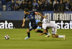 Impact’s Ignacio Piatti (left) plays the ball as Toronto FC’s Nick DeLeon loses his footing during the first half in the opening leg of the Canadian Championship final on Wednesday night at Stade Saputo in Montreal. The hosts won 1-0. (USA TODAY SPORTS PHOTO)