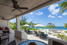 The private patio of the Saffron Suite at Spice Island Beach Resort overlooks the palm and sea grape tree-lined Grand Anse Beach. (Spice Island Beach Resort photo)