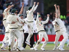 Members of Australia's cricket team celebrate the wicket of England's Craig Overton to win the match and retain the Ashes in Manchester, England, on Sept. 8, 2019.  (CARL RECINE/Reuters)