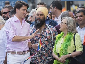 Prime Minister Justin Trudeau, left, attends the annual pride parade with NDP leader Jagmeet Singh and Green Party leader Elizabeth May in Montreal, Sunday, August 18, 2019. (THE CANADIAN PRESS/Graham Hughes)