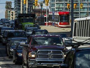 A TTC streetcar makes its way past traffic along Spadina Ave. during the afternoon rush hour on August 28, 2019.