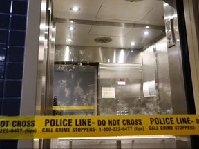 Police tape and dusted fingerprints can be seen on the glass of an elevator locked down on the 15th floor of a Scarborough apartment on Monday September 23, 2019 after a man in his 50s was found dead inside his unit on Antrim Cres. near Hwy. 401 and Kennedy Rd.