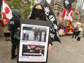 Anti-China protestors were on hand as the People's Republic of China held a flag raising ceremony at Toronto city hall on the 70th anniversary of its inception. (Jack Boland, Toronto Sun)