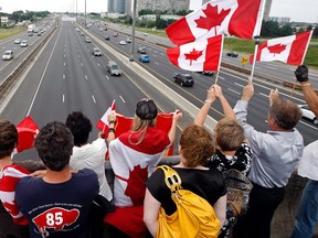 Friends and family  line the bridge at the McCowan overpass on Hwy. 401 as the body of Bradford native Brian Collier, 24, is transported along the Highway of Heroes in Toronto July 23rd, 2010. Collier was killed by an IED blast near Nakhonay, about 15 kilometres west of Kandahar city July 20,. (Dave Abel/Toronto Sun)