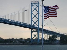 An American flag flies in front of the Ambassador Bridge  along the waterfront in Windsor, Ontario Canada.