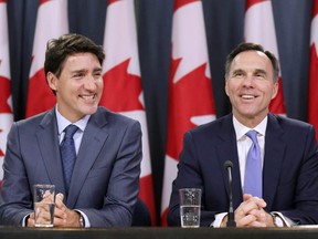 Prime Minister Justin Trudeau and Finance Minister Bill Morneau react during a news conference about the government's decision on the Trans Mountain Expansion Project in Ottawa, June 18, 2019. REUTERS/Chris Wattie