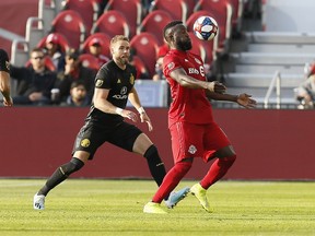 Toronto FC forward Jozy Altidore tries to control the ball as Columbus Crew SC defender Josh Williams appraoches during Sunday's game. (USA TODAY SPORTS)