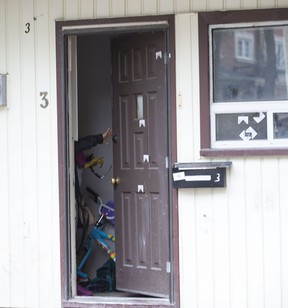 A child’s bike can be seen as a woman closes her front door riddled with bullets on Conron Place in the Weston Rd and Lawrence area Wednesday, October 30, 2019. Craig Robertson/Toronto Sun