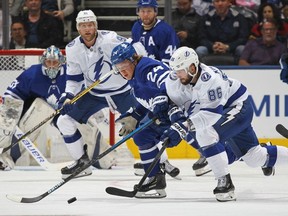 Nikita Kucherov of the Tampa Bay Lightning battles against Kasperi Kapanen of the Toronto Maple Leafs during an NHL game at Scotiabank Arena on October 10, 2019 in Toronto, Ontario, Canada.