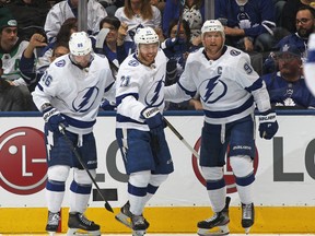 Brayden Point of the Tampa Bay Lightning celebrates a goal against the Toronto Maple Leafs with Steven  Stamkos and Nikita Kucherov during an NHL game at Scotiabank Arena on October 10, 2019 in Toronto, Ontario, Canada. (Photo by Claus Andersen/Getty Images)