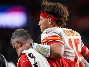 Patrick Mahomes of the Kansas City Chiefs is helped off the field by trainers after sustaining an injury in the second quarter of a game against the Denver Broncos at Empower Field at Mile High on October 17, 2019 in Denver, Colorado.