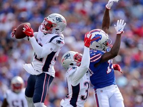 Devin McCourty of the New England Patriots intercepts a pass intended for John Brown of the Buffalo Bills during the first quarter in the game at New Era Field on September 29, 2019 in Buffalo, New York.