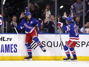 Mika Zibanejad (left) of the Rangers celebrates after combining with Artemi Panarin (right) on a highlight-reel goal at Madison Square Garden on October 03, 2019 in New York City. The Rangers defeated the Jets 6-4. (Photo by Bruce Bennett/Getty Images)